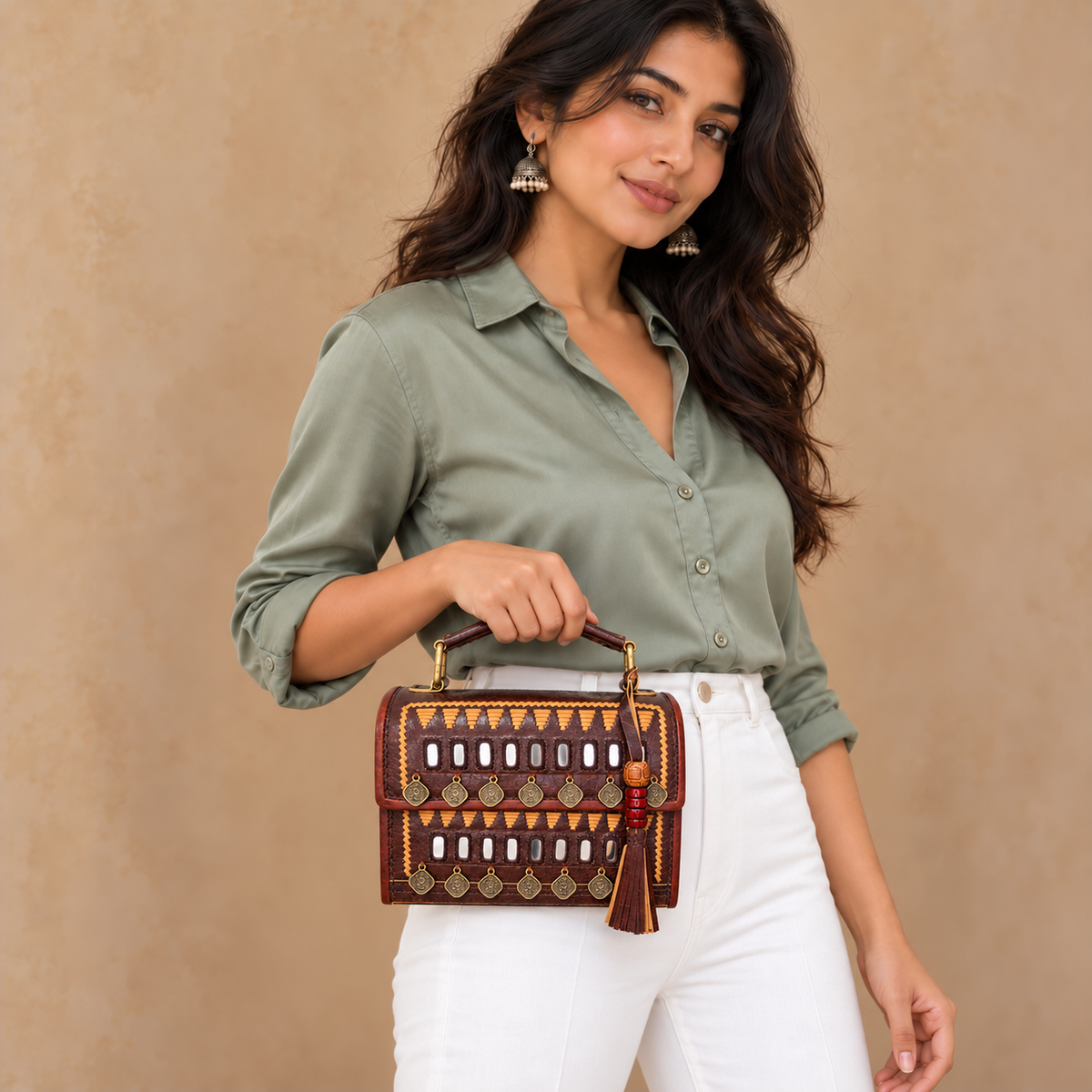 Model in sage blouse and white pants holding compact Brown Mirror & Coin Hut Handbag