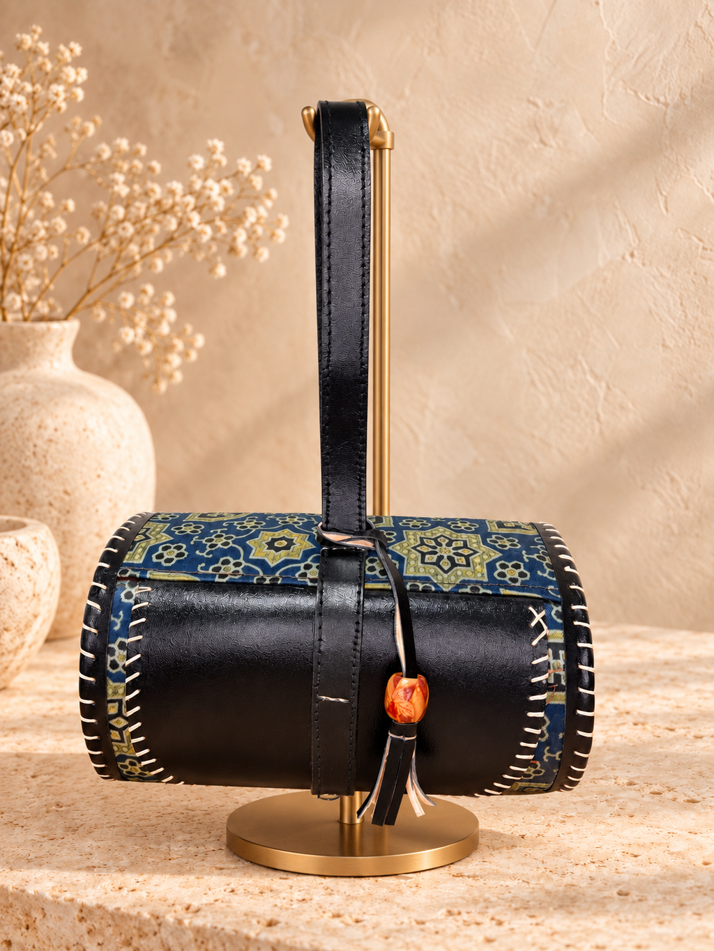 Traditional Dholak Handbag – Midnight Blue on a gold display stand