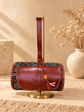 Traditional Dholak Handbag – Brown & Indigo on a gold display stand
