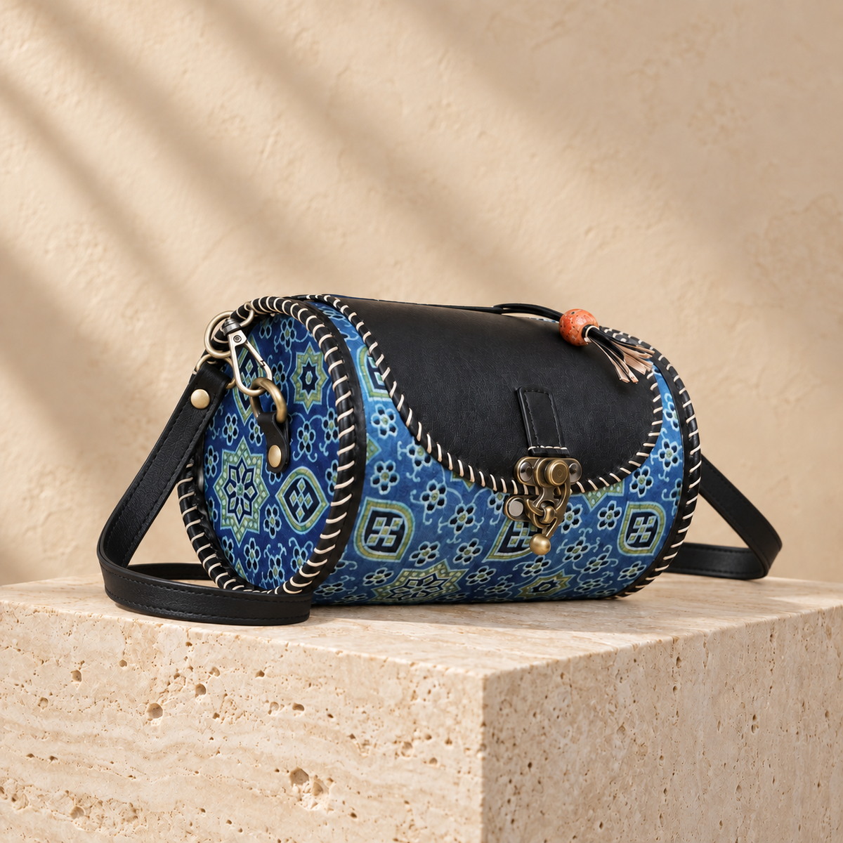 Side angle of Midnight Blue Traditional Dholak Handbag showing rounded patterned side and leather sling