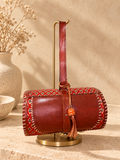 Traditional Dholak Handbag – Rust Red on a gold display stand