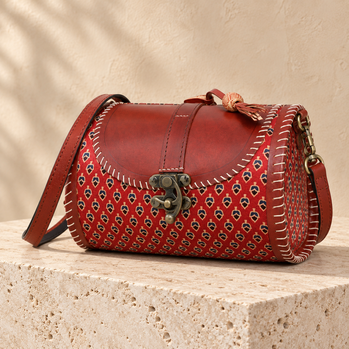 Side angle of Rust Red Traditional Dholak Handbag showing rounded side and sling attachment