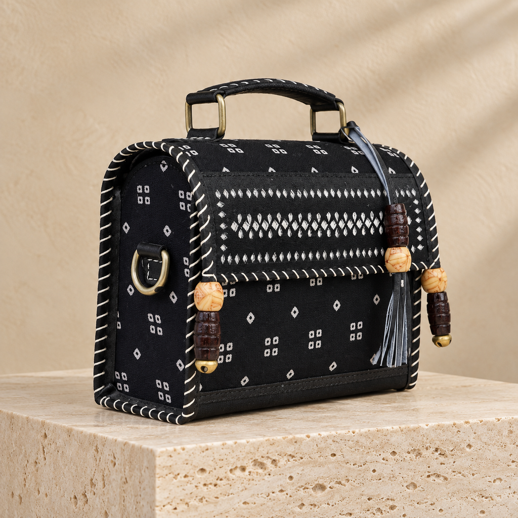 Side angle of Black Bandhej Hut Handbag showing patterned side and sling attachment