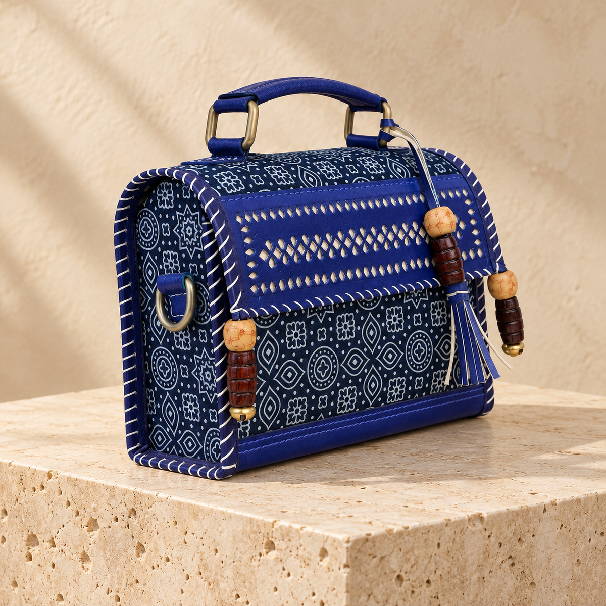 Side angle of Cobalt Blue Hut Handbag showing patterned side and sling attachment