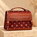 Hut Handbag – maroon bandhej – on a stone pedestal
