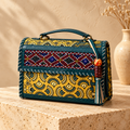 Hut Handbag in mustard teal – on a stone pedestal
