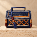 Navy Kutch Embroidery Hut Handbag on travertine pedestal