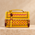 Yellow Kutch Embroidery Hut Handbag on travertine pedestal